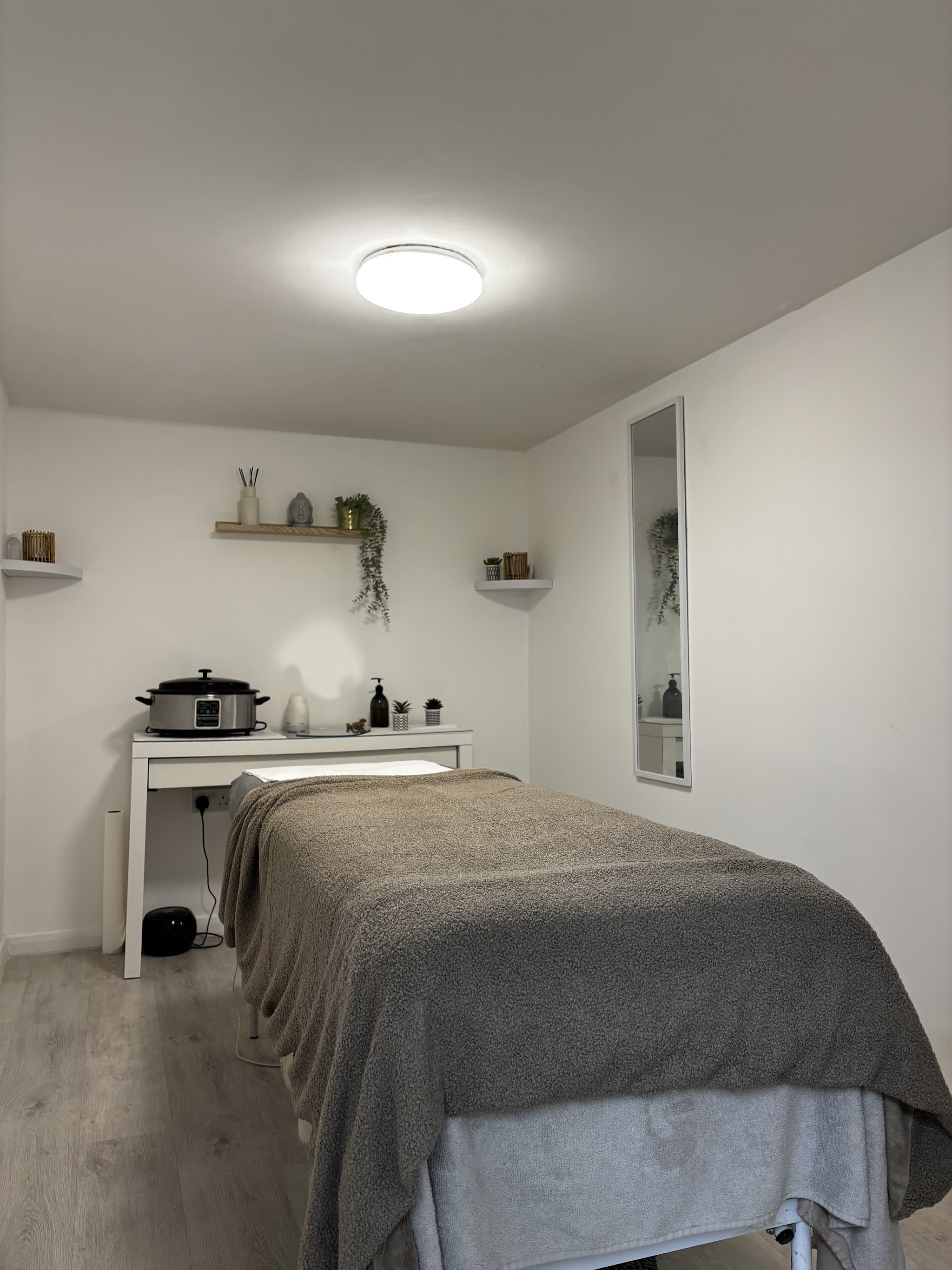 A neatly prepared massage and beauty treatment room at Doll Beauty